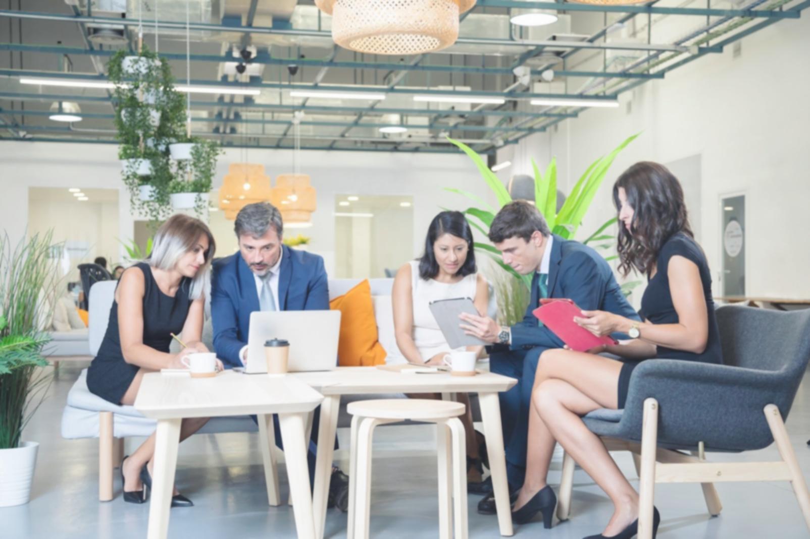 Professional training session with development team learning accessibility testing methods on laptops and mobile devices